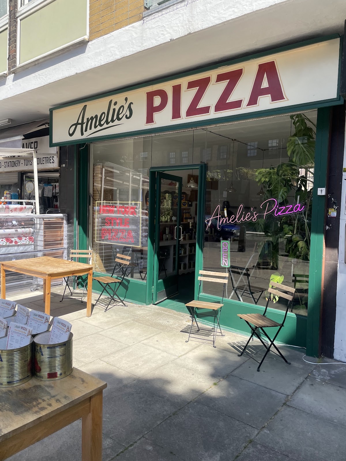 The green shopfront on Caledonian Road with outdoor tables and chairs